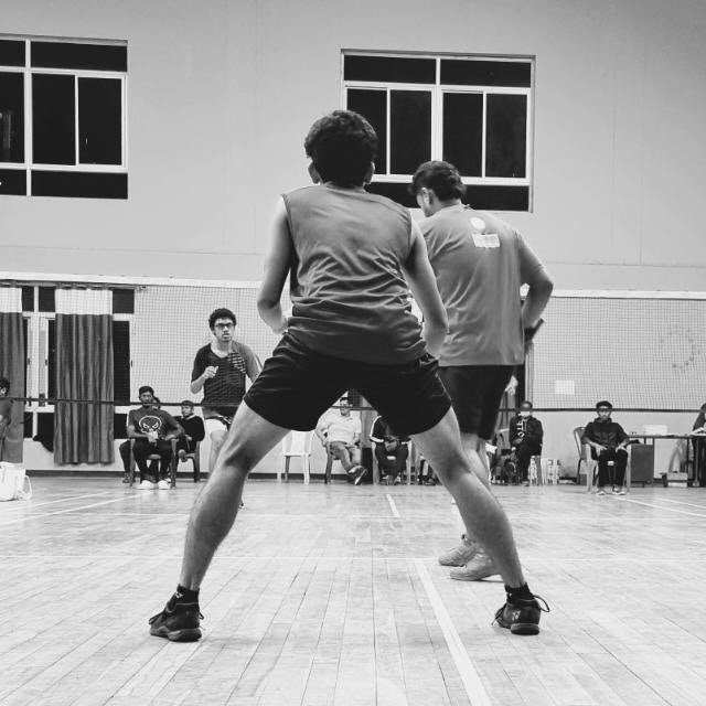 Joshua Martin playing competitive badminton, action photograph