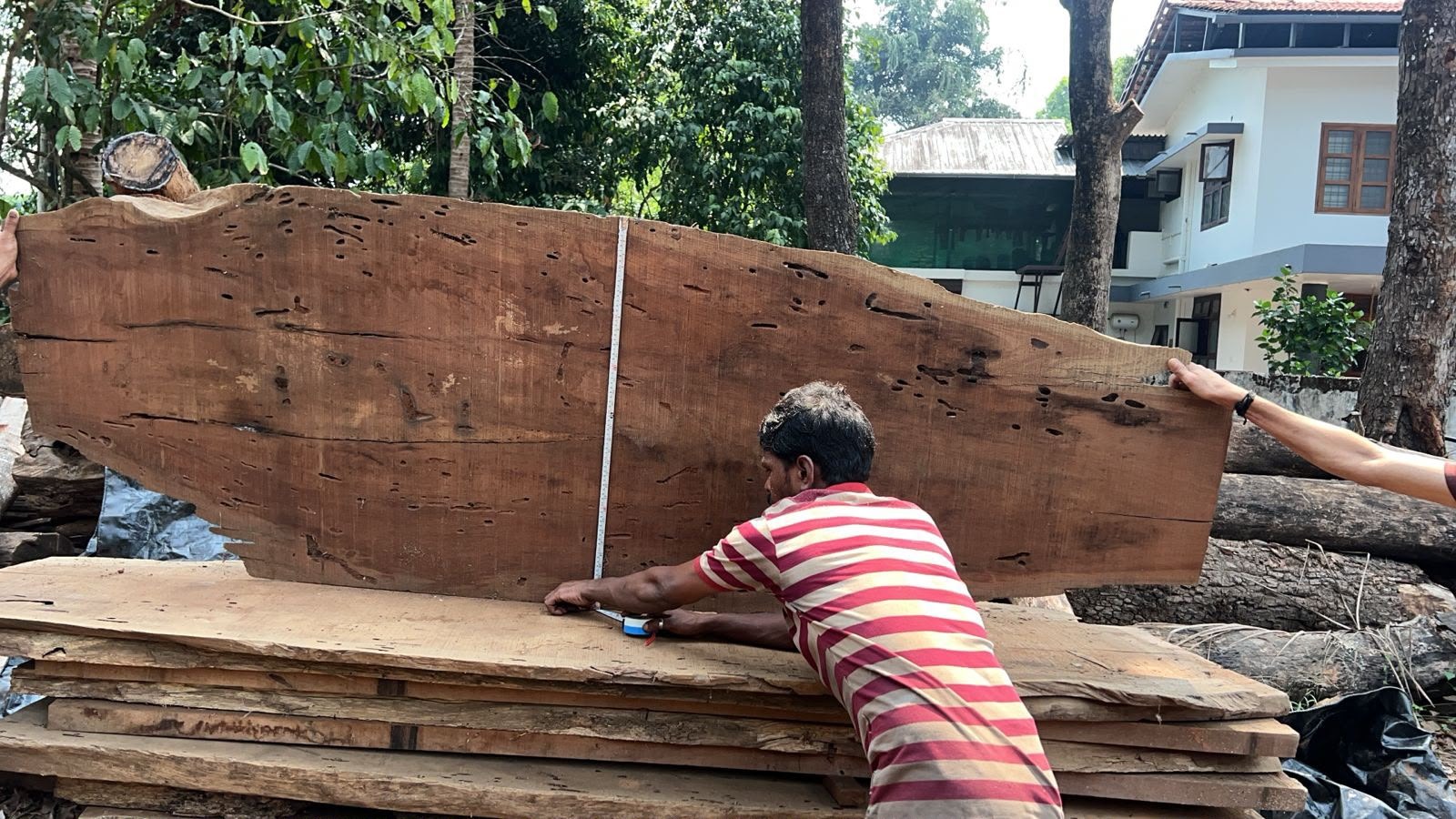 Measuring timber planks on a construction site